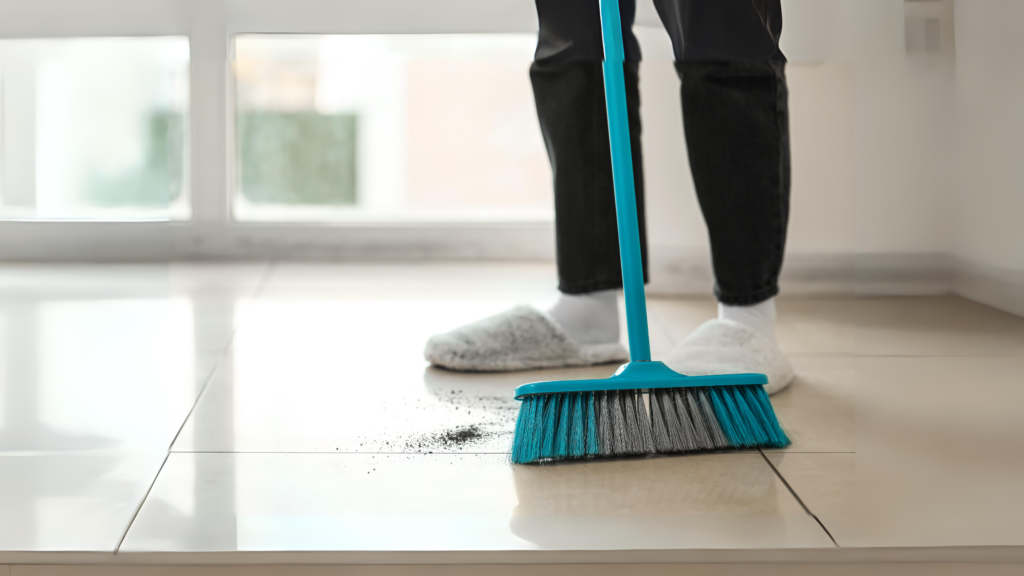 sweeping and removing dirt on tile floors